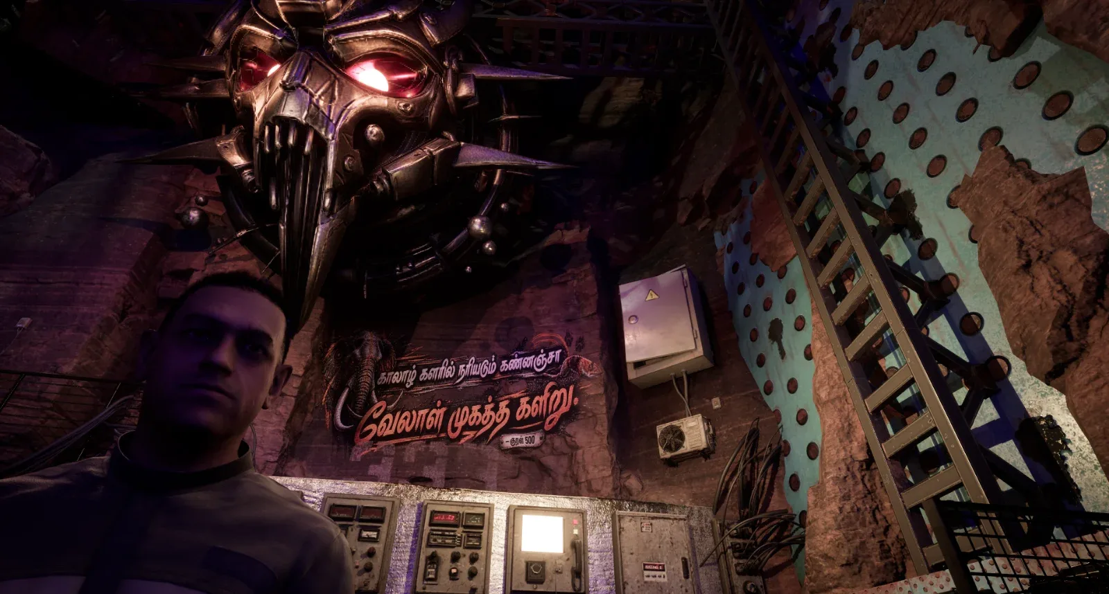 Dr. Sanjay beneath the emblem in the Megamalai lab