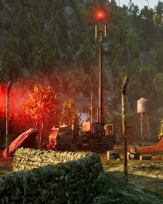 A signal truck with a red beacon behind a dry-stone wall